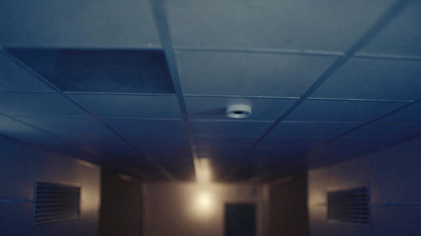 A corridor ceiling grid with a discreet occupancy sensor