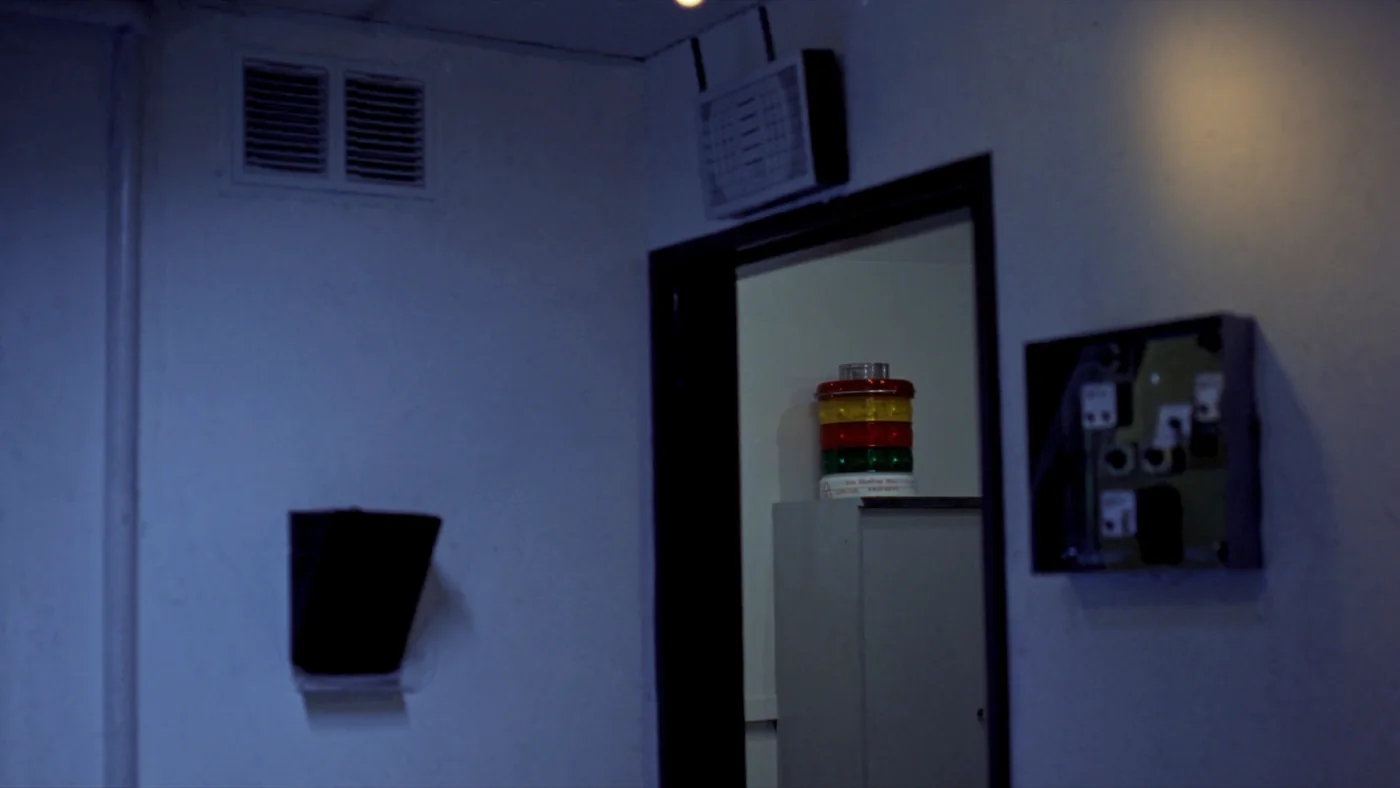 A basement plant room with a wireless repeater above the doorway