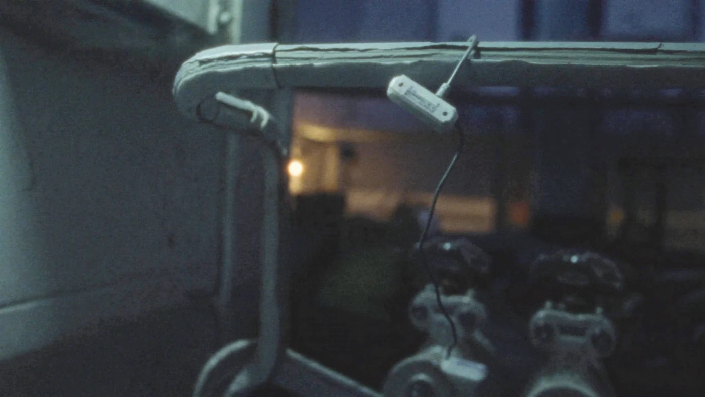 A sensor node clipped to a flow pipe with insulation cut back