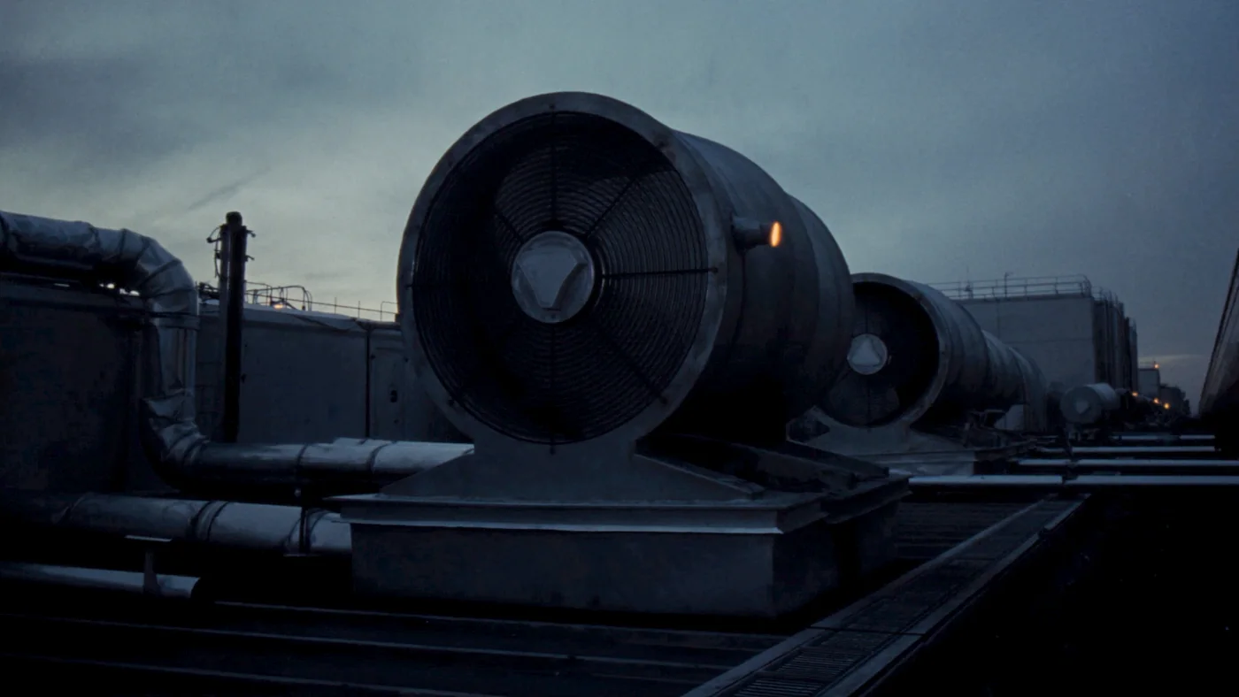 Rooftop air handling units on a UK office block silhouetted at dusk