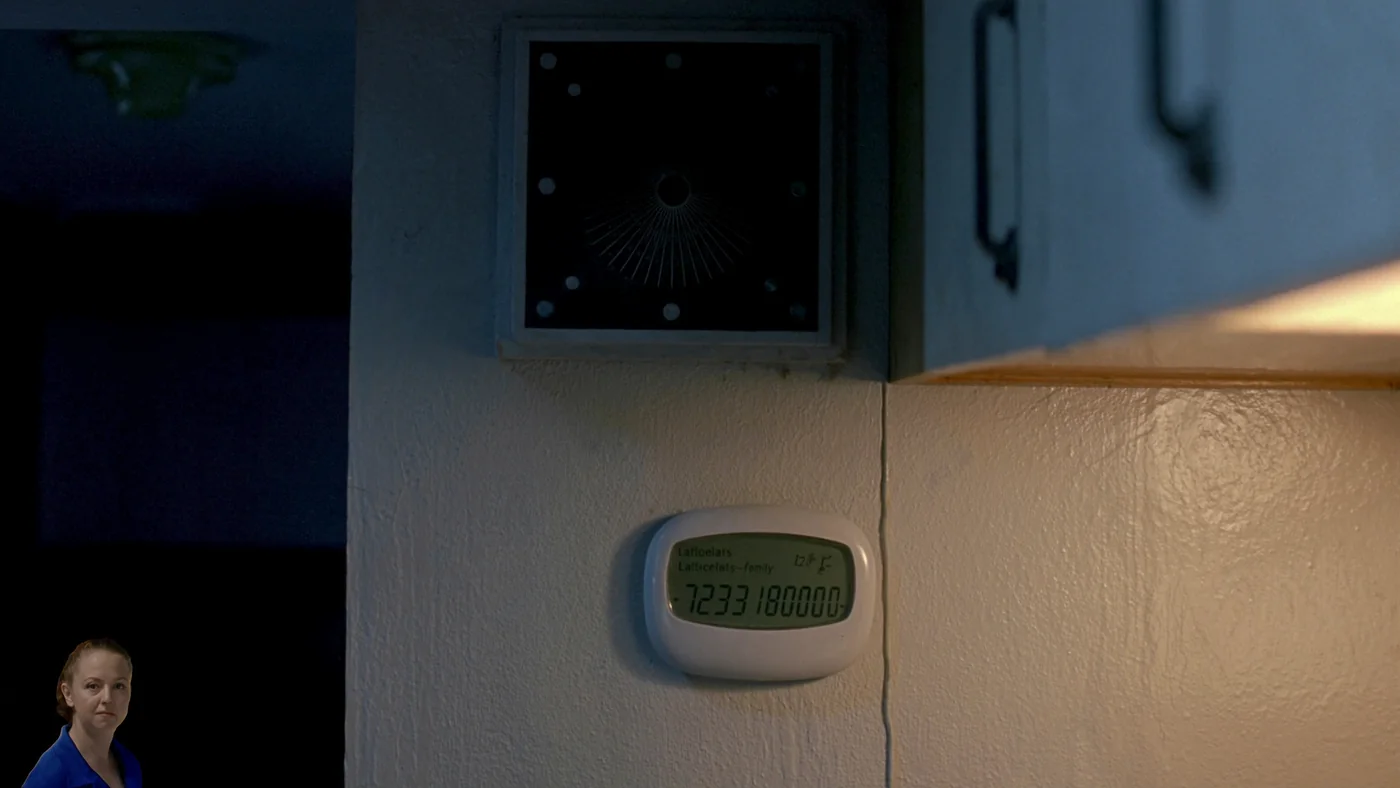 A temperature and humidity sensor on the wall of an occupied flat, softly lit