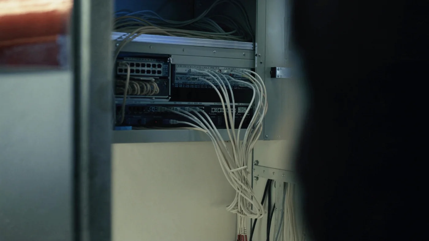 A building services network cabinet with neat patch cabling in a riser