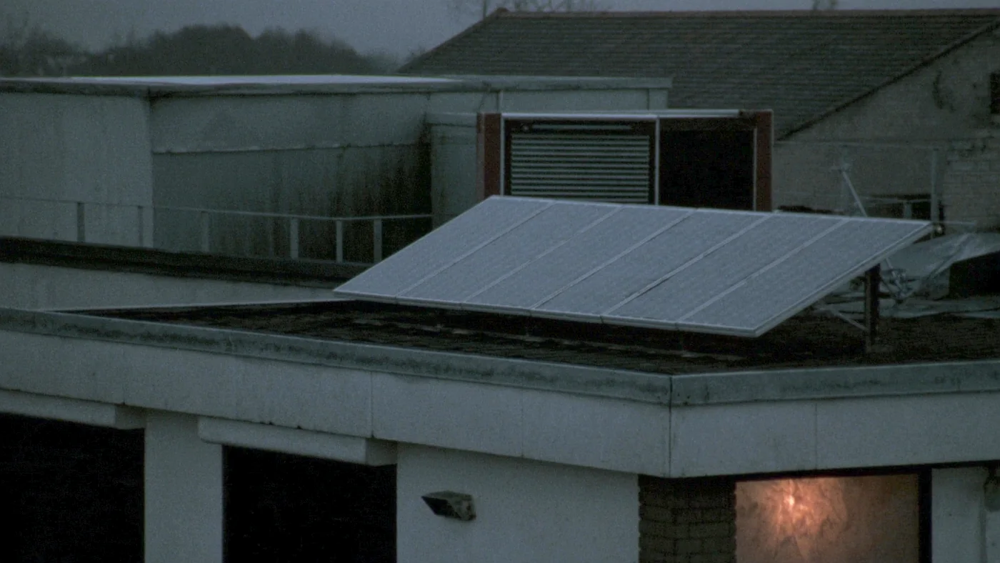 A community solar array on a flat roof above a leisure centre