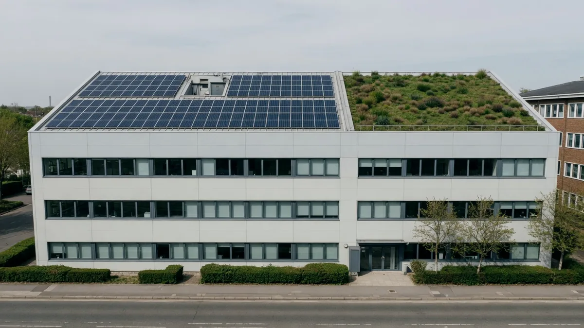 A modern office building with solar panels and a green roof